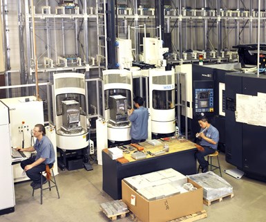 Machinists producing ventilator parts